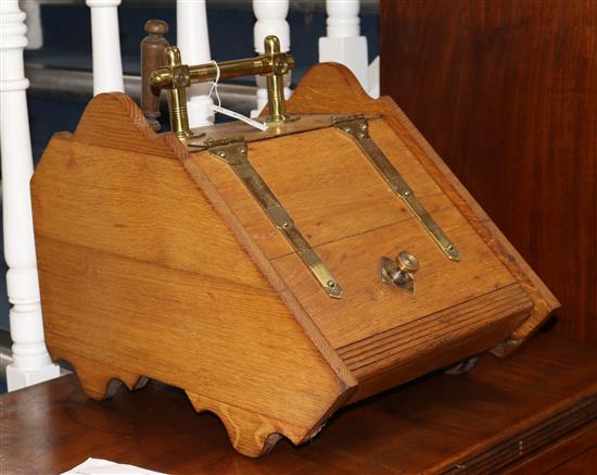 A Victorian oak and brass bound coal box with shovel, with sloping top, brass strap hinges and handle